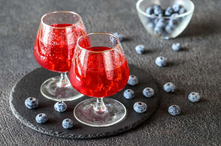 Two glasses of blueberry juice with fresh berries