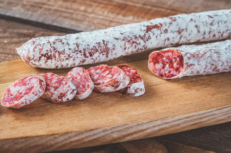 Fuet -  Catalan dry cured sausage on the wooden board