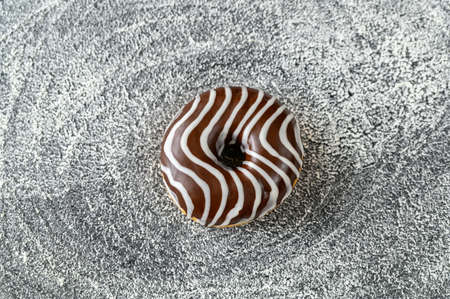 Chocolate donut on floured surfaceの写真素材