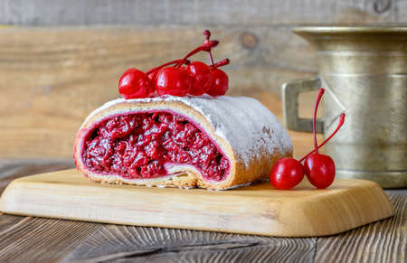 Strudel with cherry filling on wooden backgroundの写真素材