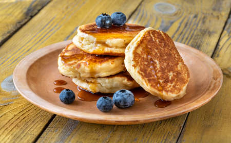 Stack of ricotta pancakes with blueberries on the plate 