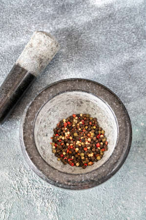 Grinding of peppercorn mix in granite mortarの写真素材