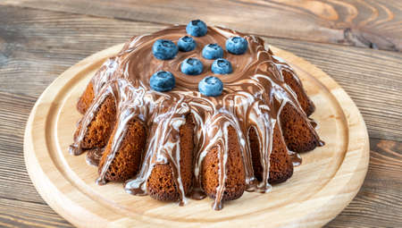 Cake with chocolate topping and fresh berries