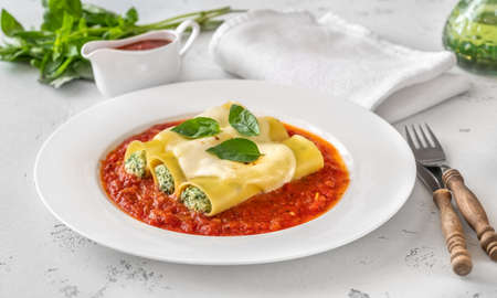 Cannelloni pasta stuffed with ricotta and spinach with tomato sauceの写真素材
