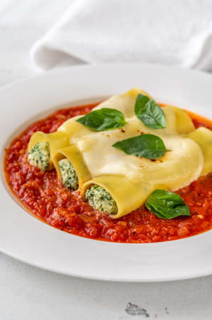 Cannelloni pasta stuffed with ricotta and spinach with tomato sauceの写真素材