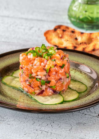 Portion of salmon tartare with grilled ciabattaの写真素材