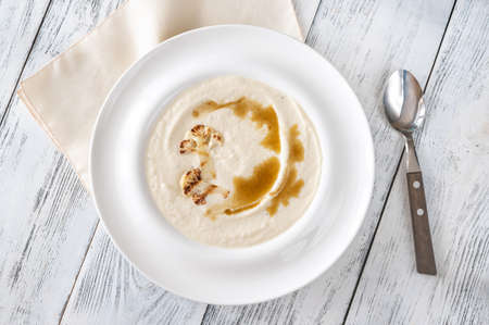 Cauliflower soup with brown butter in white plateの写真素材