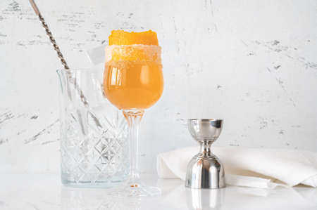 Glass of Brandy Crusta cocktail garnished with orange zestの写真素材