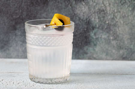 Glass of Casino cocktail garnished with a lemon zest and a maraschino cherryの写真素材