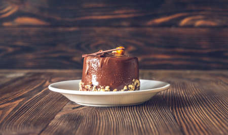 Decorated chocolate cake on the white saucerの写真素材