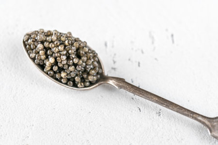 Silver teaspoon of black caviar close upの写真素材