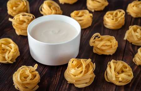 Bowl of bechamel sauce with tagliatelle pasta