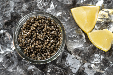 Glass bowl of black caviar with crushed iceの写真素材