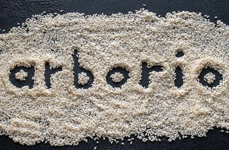 Uncooked arborio rice on the wooden backgroundの写真素材