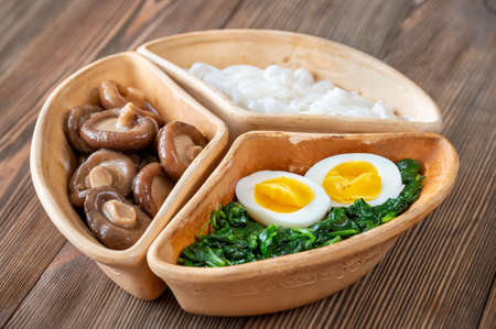 Healthy bowl with rice noodles, marinated shiitake and steamed spinachの写真素材