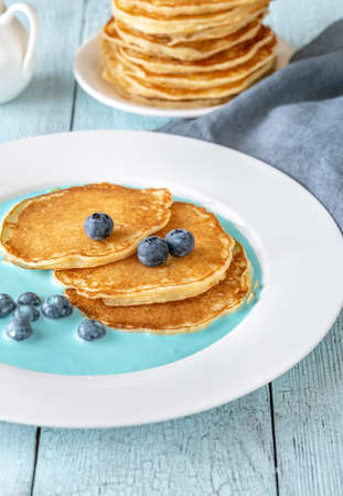 Pancakes with fresh blueberries and cream sauceの写真素材
