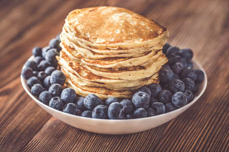 Bunch of pancakes with fresh blueberries