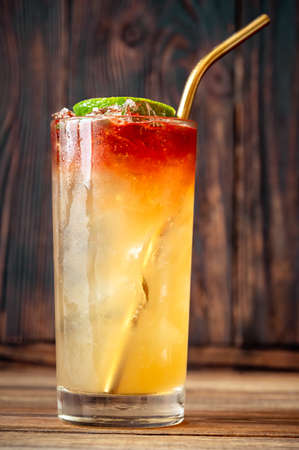Glass of Holy water cocktail on the wooden background