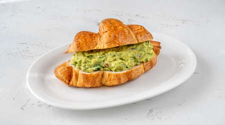 Croissant with guacamole on the serving plateの写真素材