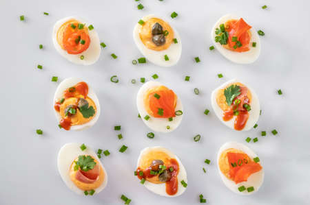 Sriracha deviled eggs with different toppings