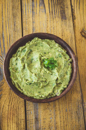Bowl of fresh guacamole on rustic backgroundの写真素材