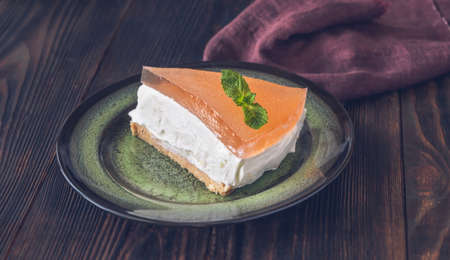 Piece of grapefruit cheesecake on rustic backgroundの写真素材