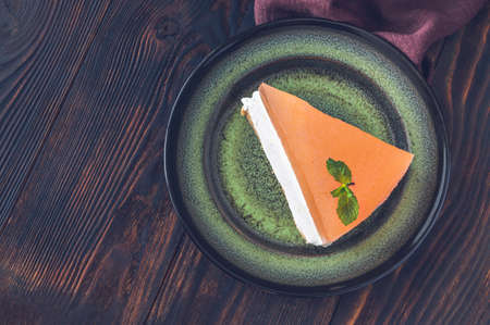 Piece of grapefruit cheesecake on rustic backgroundの写真素材