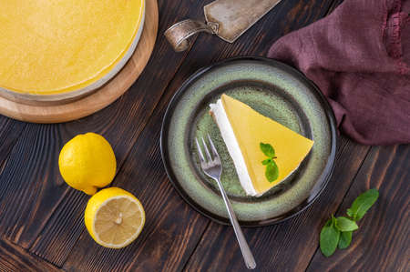 Piece of gin and tonic lemon cheesecake on rustic backgroundの写真素材