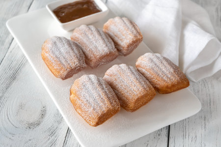 Madeleines - French small sponge cakes on the serving plate