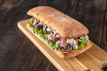 Steak Sandwich with mushrooms, blue cheese, red onions and fresh lettuceの写真素材