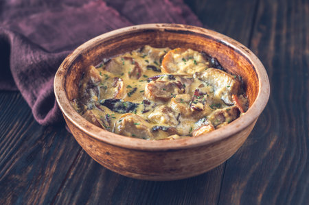 Creamy garlic mushrooms and bacon in the bowlの写真素材