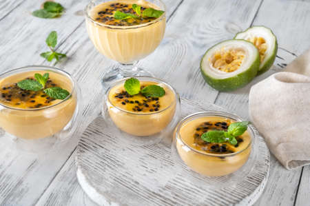 Bowls of passion fruit mousse garnished with passion fruit fruitの写真素材