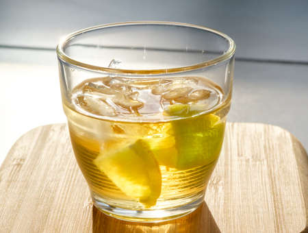 Glass of golden rum on the rocks