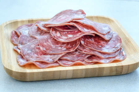Heap of Salchichon sausage in wooden plate