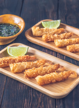 Shrimp tempura with lime wedges on the plate