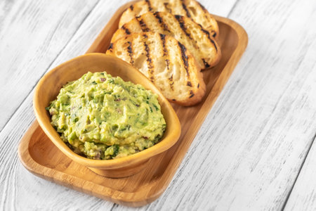 Bowl of guacamole on white backgroundの写真素材