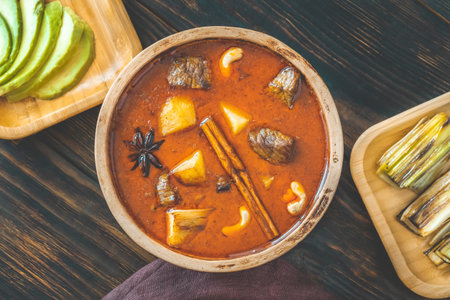 Bowl of Massaman curry on the wooden backgroundの写真素材