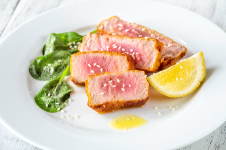 Sliced tuna steak on the white plateの写真素材