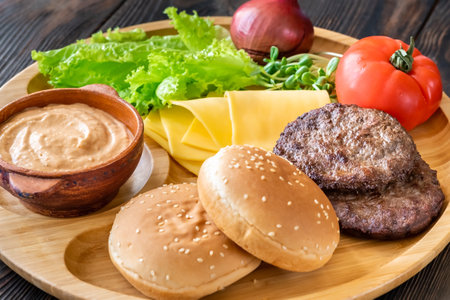 Ingredients for burgers on the wooden trayの写真素材