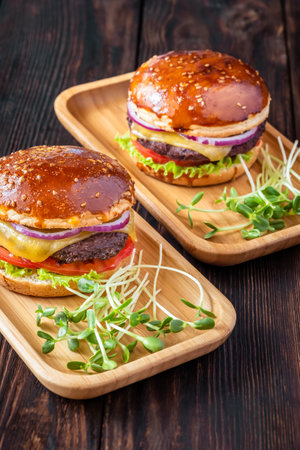 Two glazed burgers on the wooden backgroundの写真素材