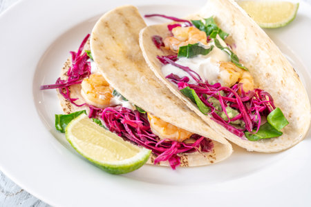 Tacos with shrimp, red cabbage, guacamole and sour creamの写真素材