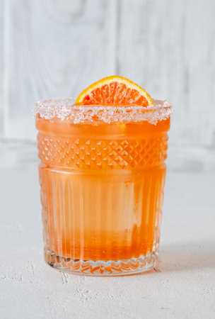 Blood Orange Margarita cocktail garnished with orange wheelの写真素材