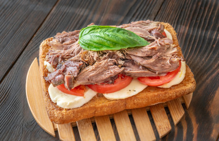 Sandwich with pulled pork, tomato, mozzarella and basil