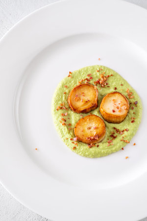 Fried eryngii wit green pea sauce and baconの写真素材