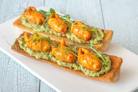 Toasts with avocado guacamole and crab claws