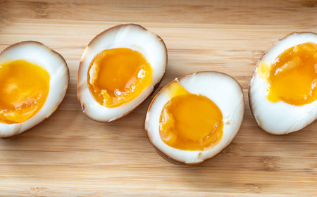 Halved soft boiled eggs marinated in soy sauceの写真素材