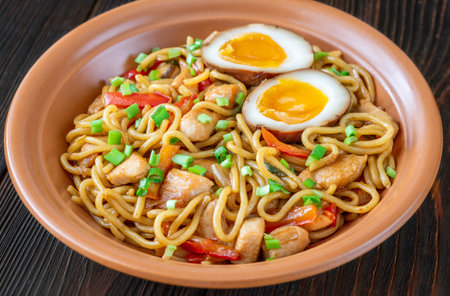 Bowl of Chicken Ramen Noodles garnished with spring onionの写真素材