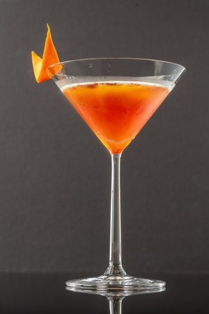 Cocktail garnished with orange zestの写真素材
