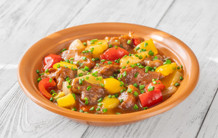 Portion of sweet and sour pork with bell pepper and pineappleの写真素材