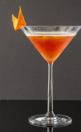 Cocktail garnished with orange zestの写真素材